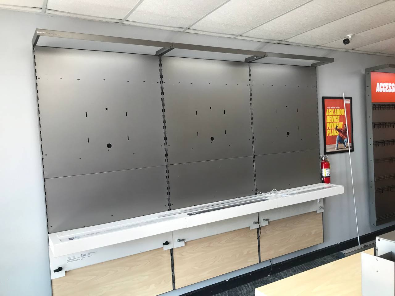 Retail fixture wall and shelving being stripped out of a commercial unit