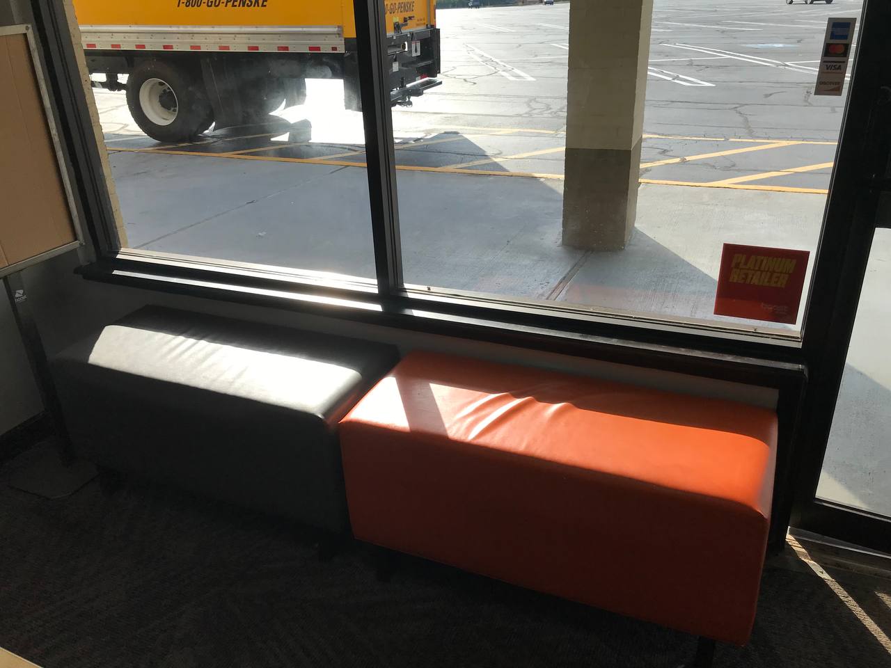 Box truck backed up to the storefront during a commercial move by Clays Moving