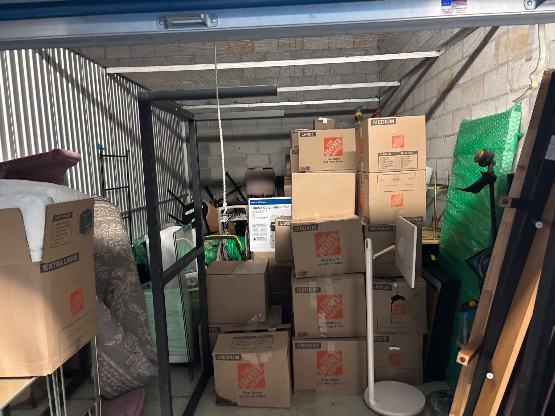 Storage unit filled with stacked labelled moving boxes